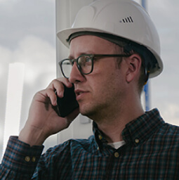 Man in hardhat on the phone 