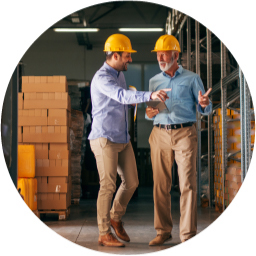 Distributor employees discussing inventory in a warehouse