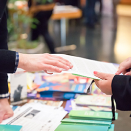 Two hands passing a document 