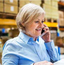 Lady talking on phone in warehouse