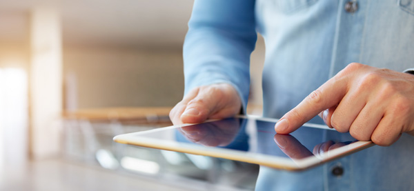 A person working on their tablet