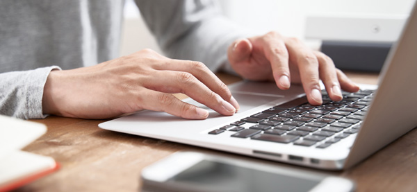 Website agency employee working on laptop