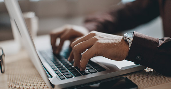 Person writing copy on laptop 