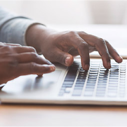 Person typing on a laptop 