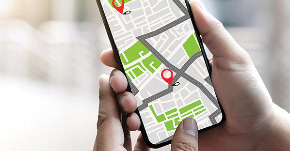 Cell phone in hand showing geographic market